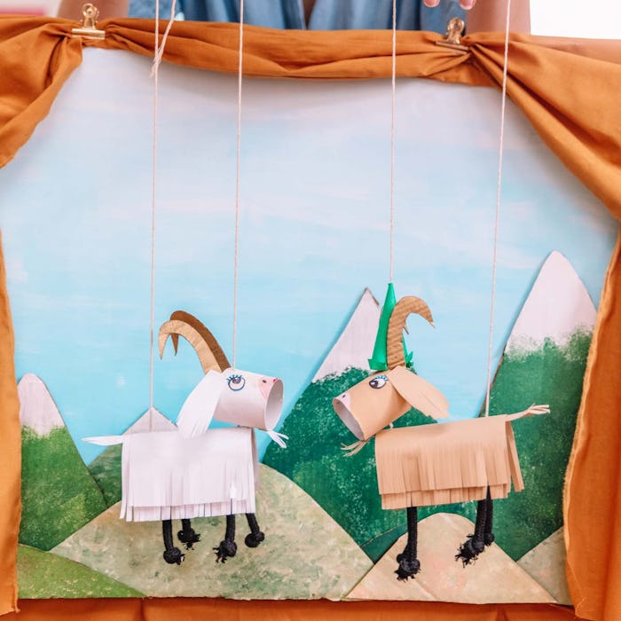 A lonely pair of paper goat marionettes on a mountain top.