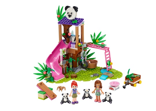 Two LEGO Friends kids beside three panda characters in front of a LEGO jungle gym.