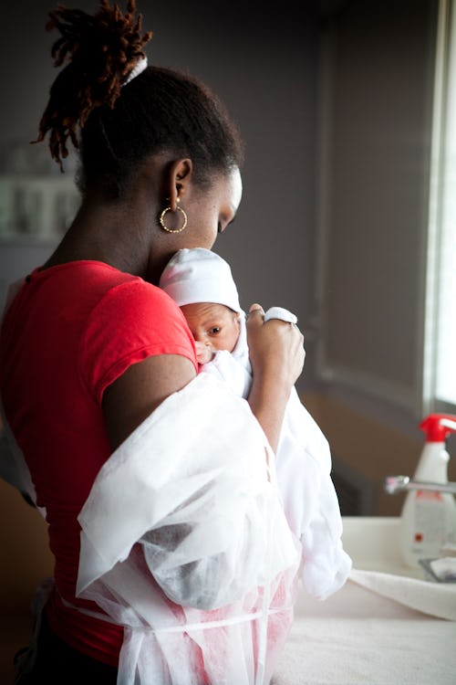 A mother holds newborn in maternity ward in France
