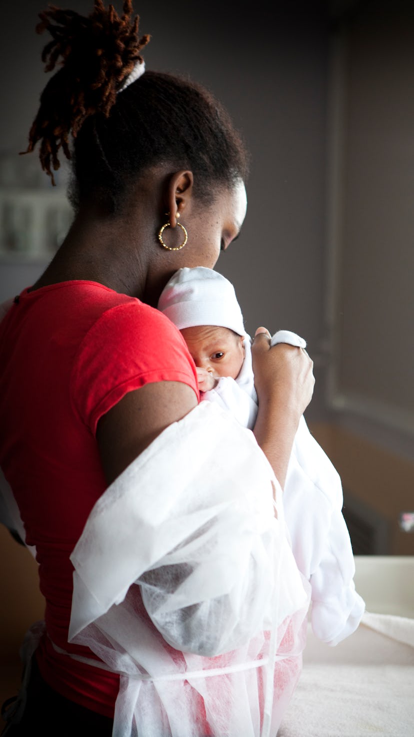 A mother holds newborn in maternity ward in France