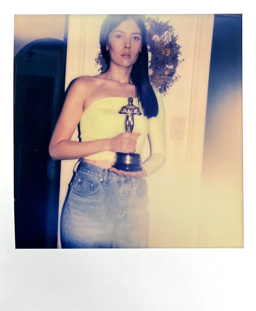 Patti Harrison holding the Oscar statuette 
