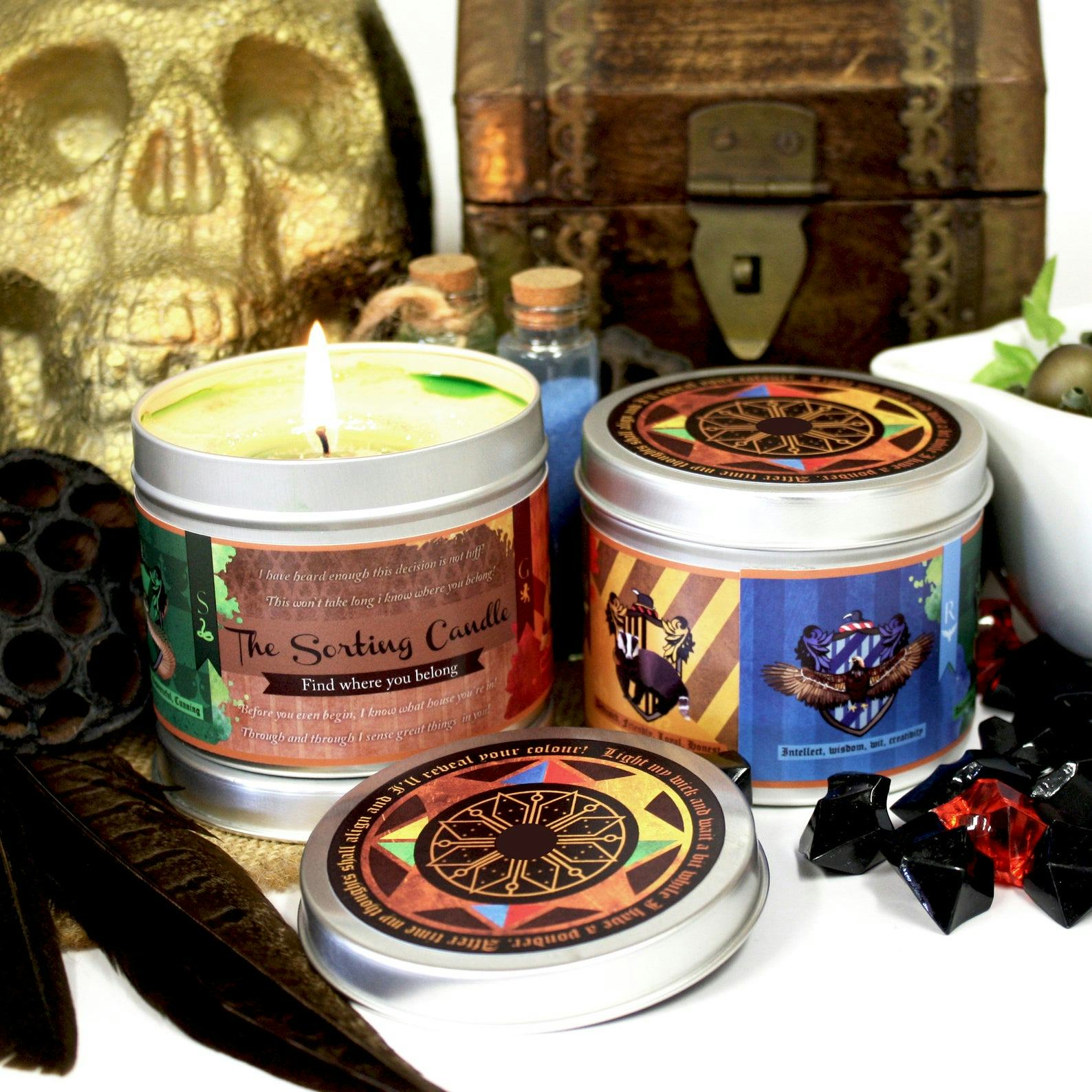 Two sorting hat candles from 'Harry Potter' sit on a desk with different magical object surrounding ...