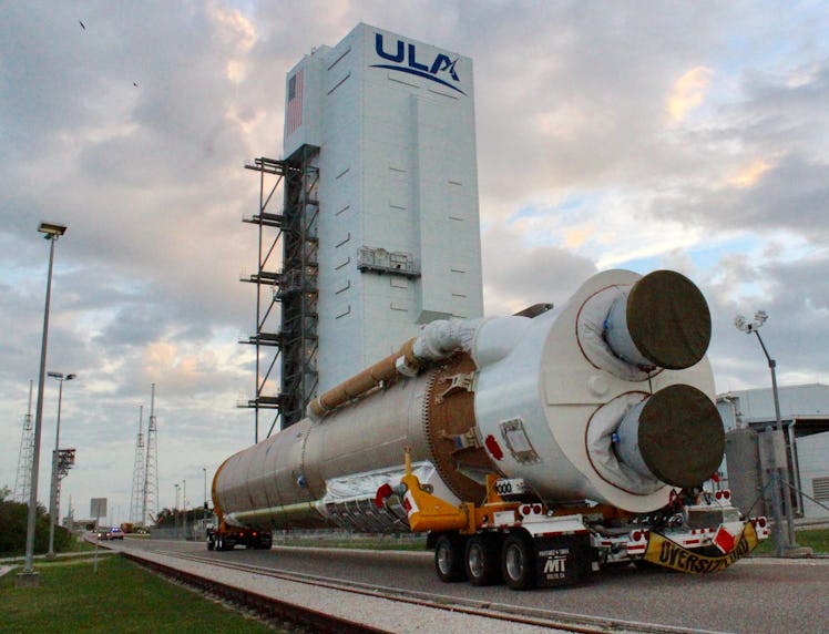 The first stage of the Atlas V arriving at a vertical integration facility, where it will be fitted ...