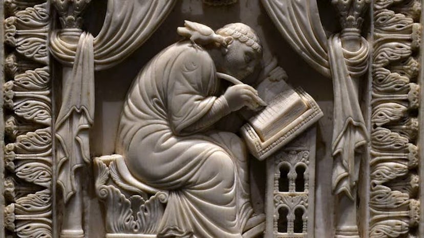 Ivory carving of St. Gregory writing about the life of St. Benedict of Nurcia, 11th century. 
