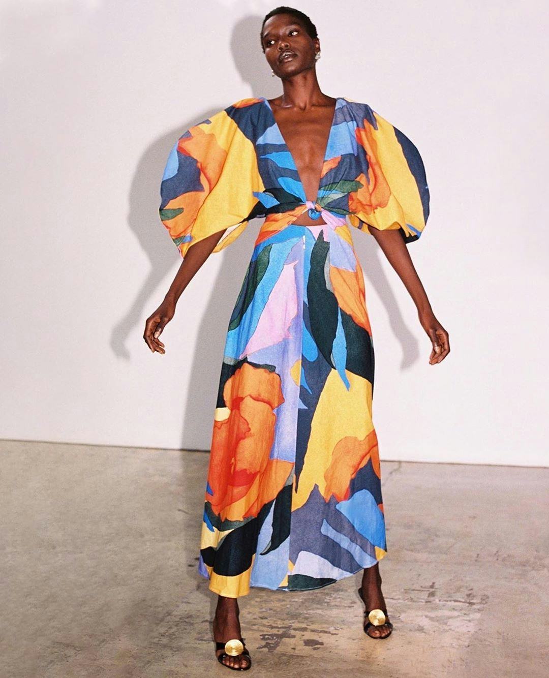 A model with a short haircut wearing Mara Hoffman Leila Dress