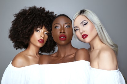 Three models with diverse skin tones wearing the Lip Bar's Bawse Lady Lipstick