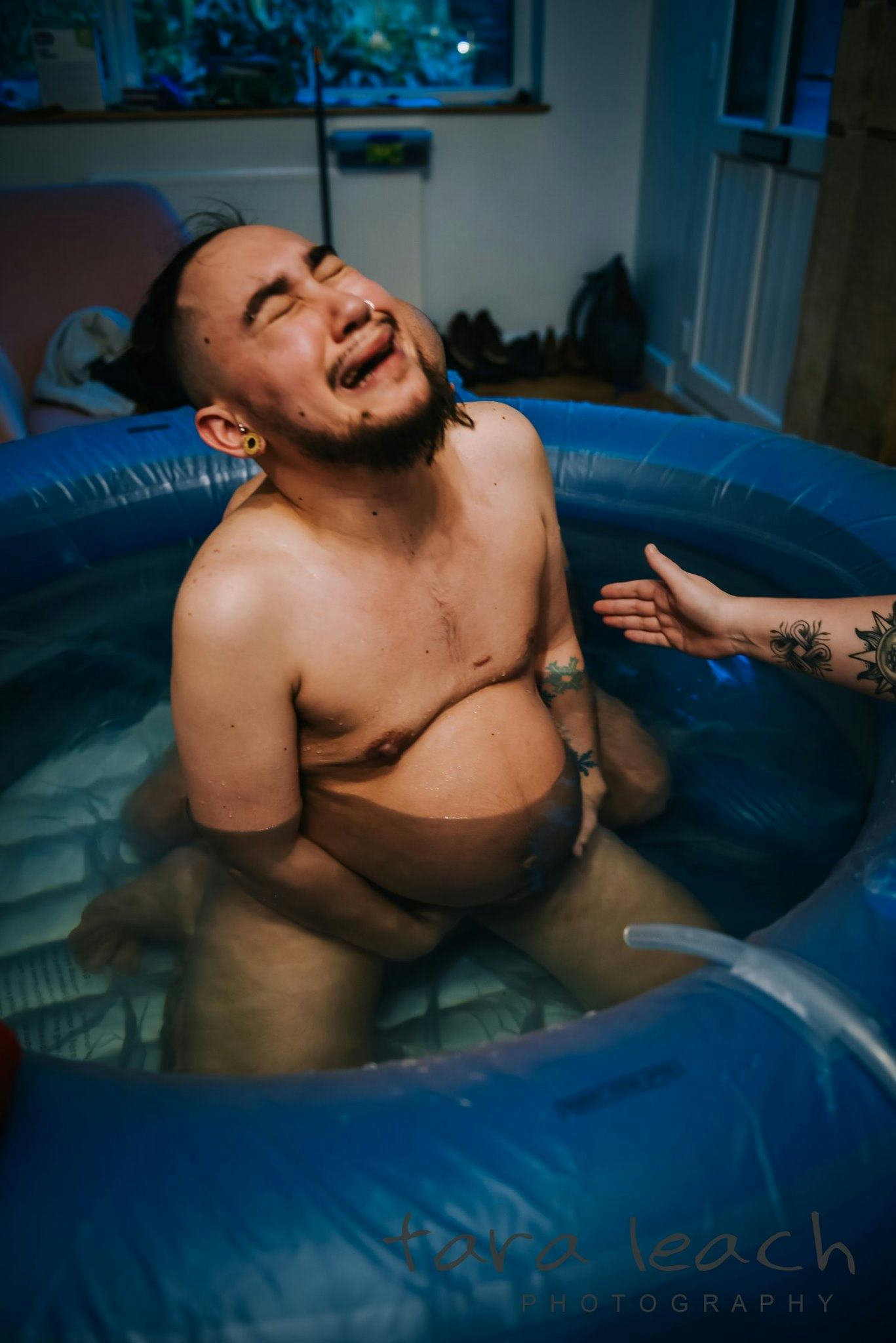 An England-based transgender dad has shared a stunning set of home birth photos in an effort to norm...