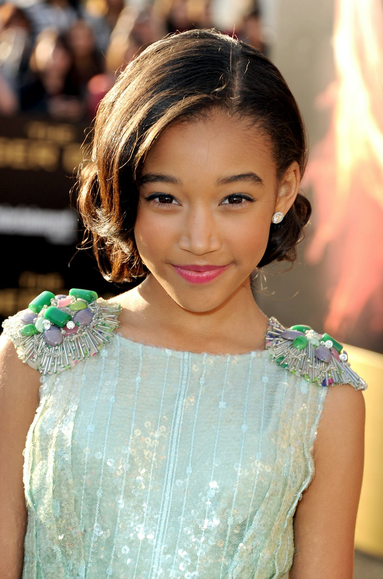 Young Amandla Stenberg in a silver dress 