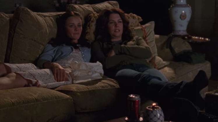 Rory and Lorelai sit on their couch at home, watching TV in 'Gilmore Girls.'