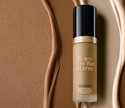Born this way matte foundation in it's bottle on a background of different shades of foundation