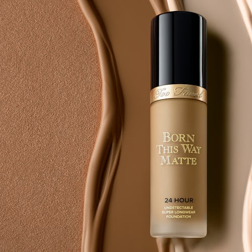 Born this way matte foundation in it's bottle on a background of different shades of foundation