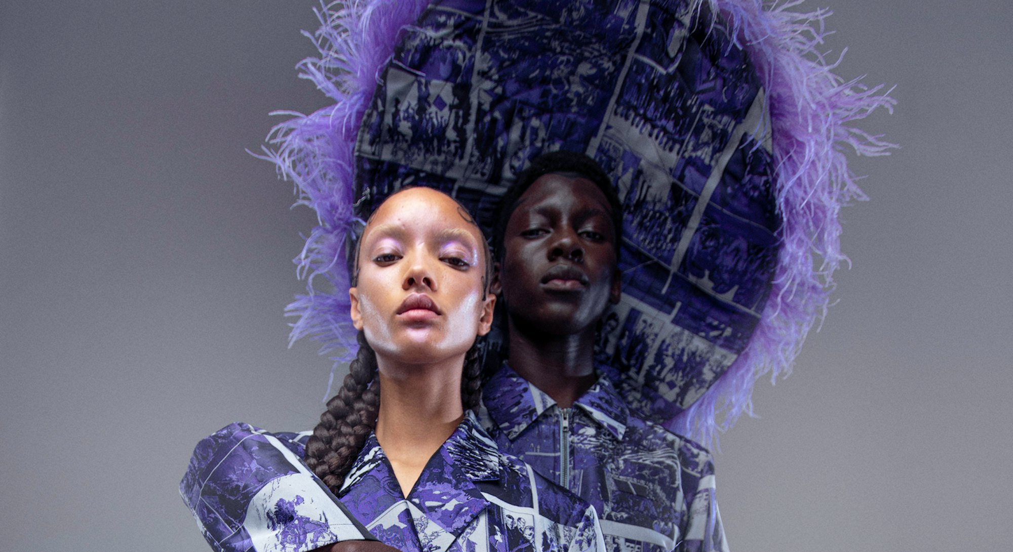 Male and female models pose in lavender suits. 