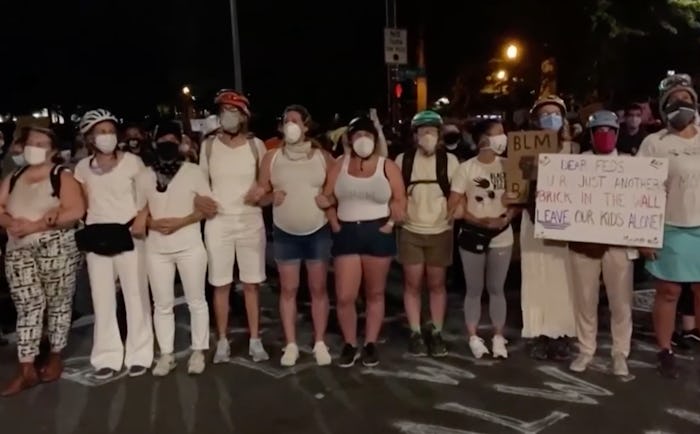 Moms formed a human shield to protect protesters in Portland, Oregon, from aggressive federal office...