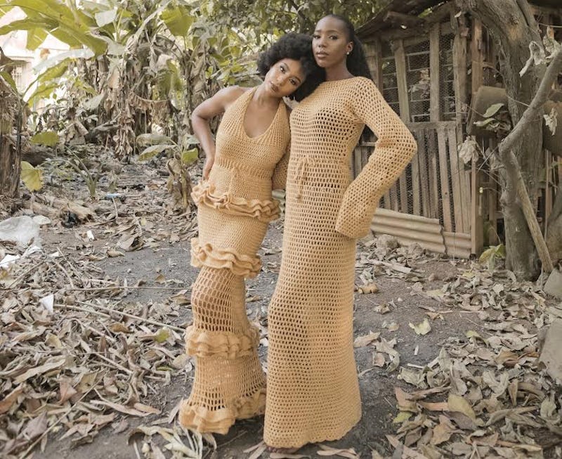 Two women posing in custom designed clothing 