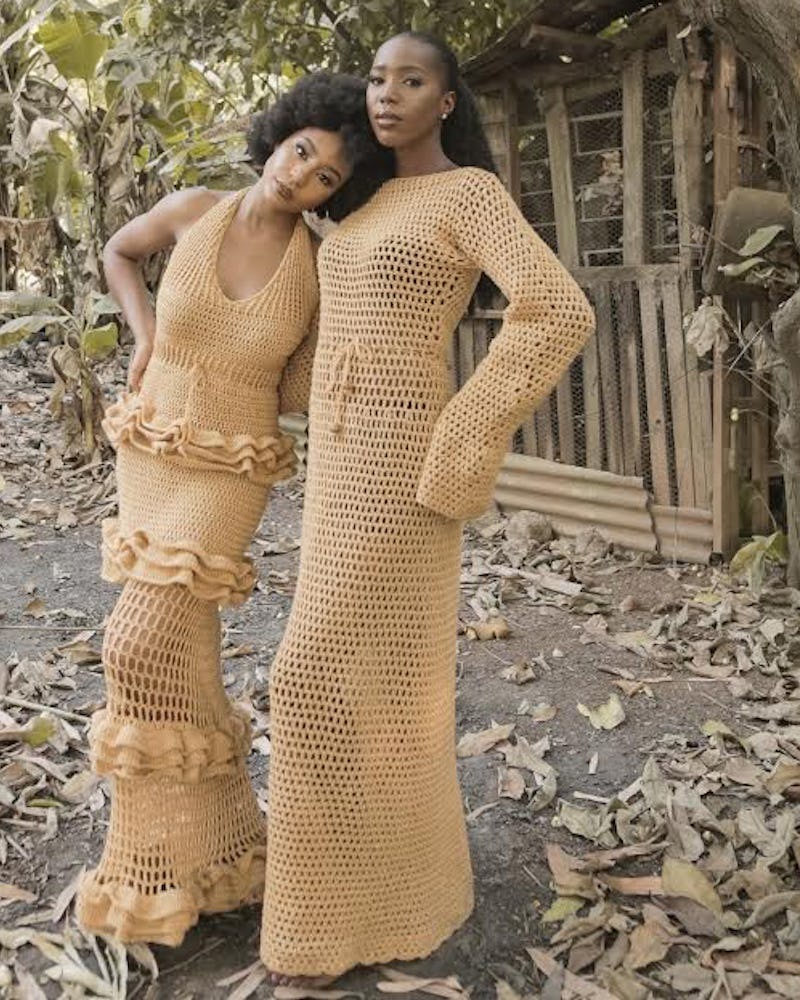 Two women posing in custom designed clothing 