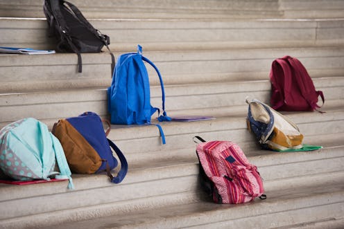 Backpacks rest on school steps. Teachers explain the debate around school reopening.