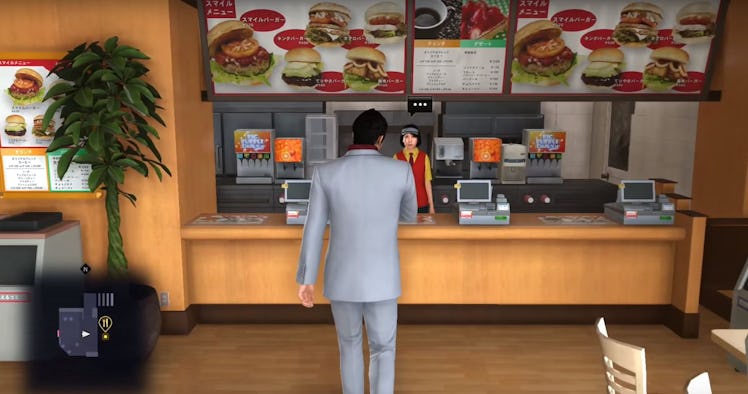 A character standing at a fast food place looking at the menu in Yakuza 6 