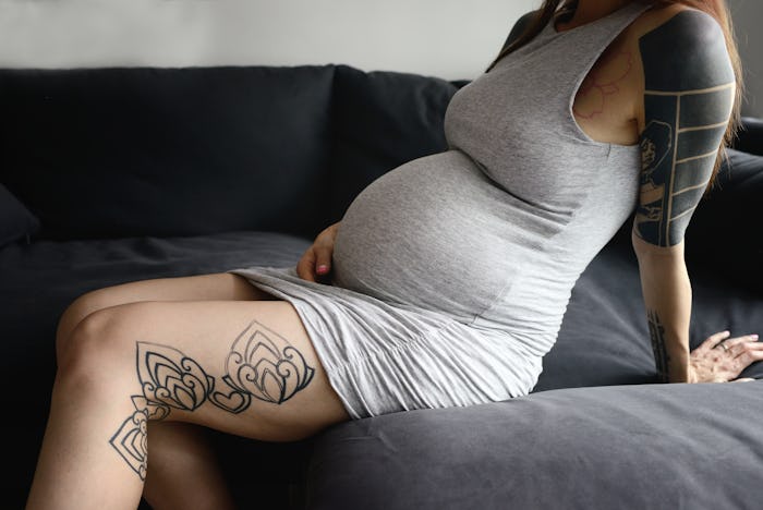 pregnant woman sitting on bed