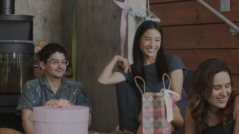 Josh Fadem, Constance Wu, and Jenée LaMarque sit around at a party in a still from The Feels