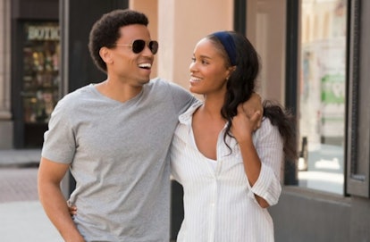 Michael Ealy and Joy Bryant walk arm in arm in a still from About Last Night
