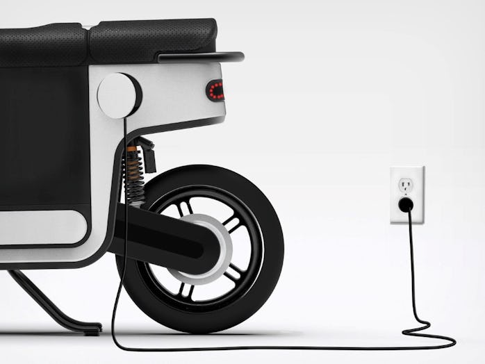 An electric scooter plugged in to charge.
