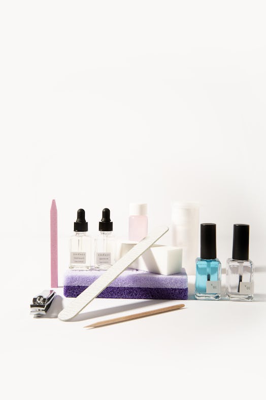 A nail clipper, a cuticle pusher, a nail file, a buffer, cuticle oil and nail polish for an at-home ...