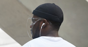 Model wearing a beanie and a face shield.