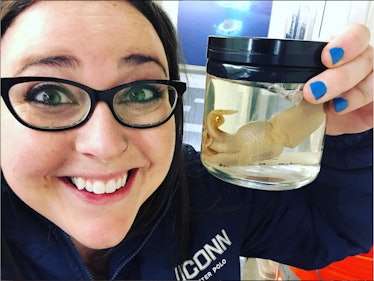 Molecular biologist Sarah McAnulty posing with squid.