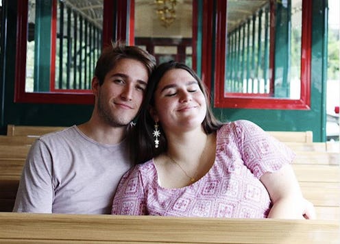 A transnational couple affected by COVID cuddle in happier times.