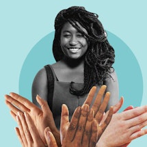 Sophie Duker smiling broadly with a variety of hands in front of her clapping