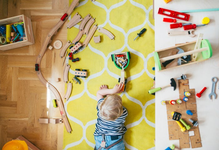 little boy playing with toys in playroom