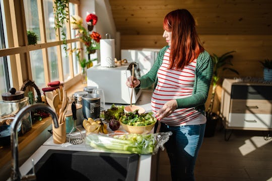 pregnant mom prepping dinner