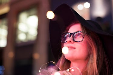 Young woman enjoying bright neon lights of street, London, UK