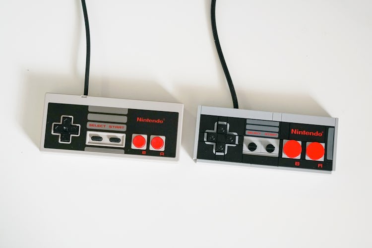 The NES Classic controller next to the Lego version. Note the larger A and B buttons on the Lego rep...