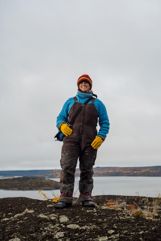 Kielyn Marrone stands on a rock by Great Slave Lake in Canada's Northern Territories