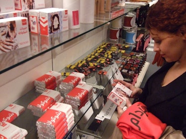 Red-haired young woman looking at El Hema products