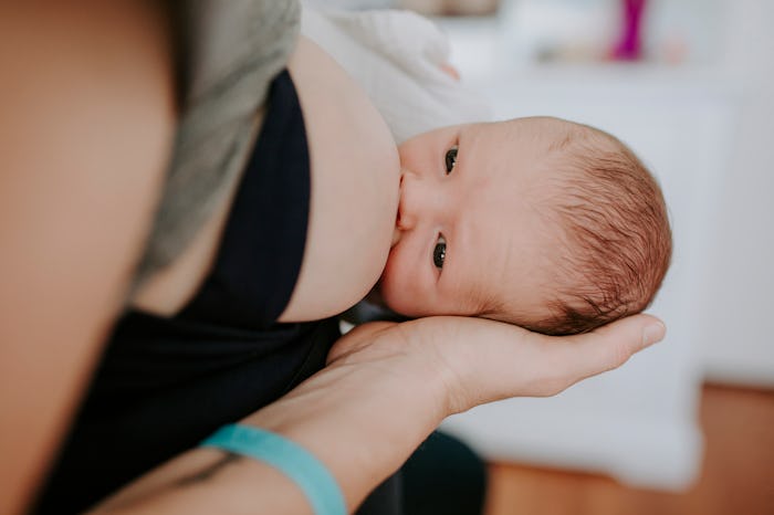 woman breastfeeding baby wearing a comfortable nursing bra