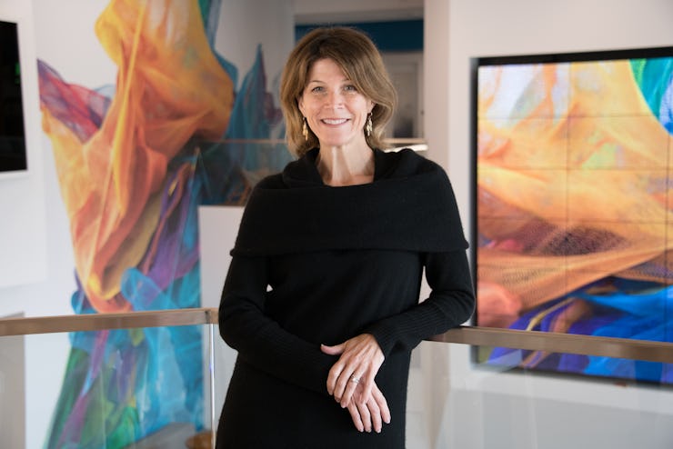 Senior VP and general manager of digital media at Adobe Ashley Still posting next to a screen displa...