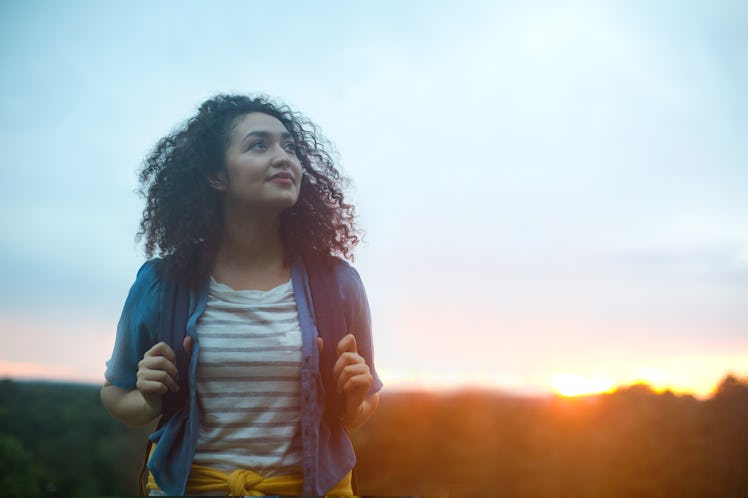 Young woman hiking at dawn in August