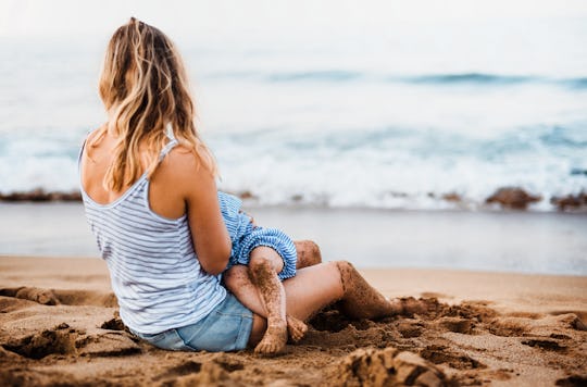 woman breastfeeding on the beach