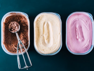 Chocolate, vanilla, and strawberry ice cream in containers.