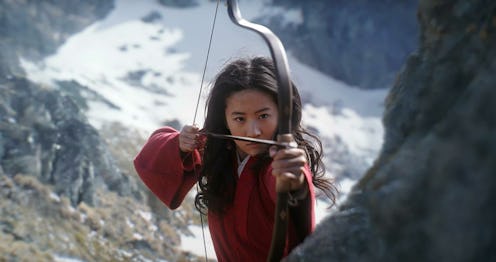 Liu Yifei as Mulan holding a bow and arrrow in a still from the film