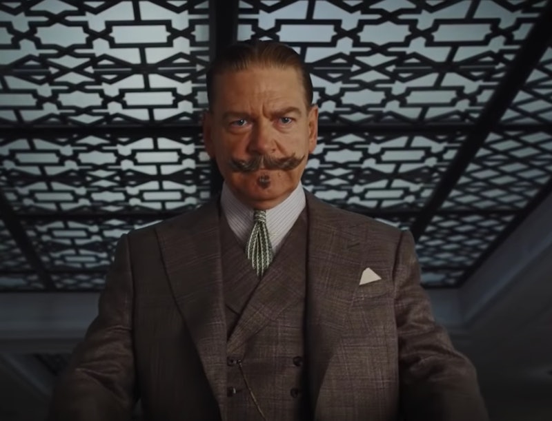 Kenneth Branagh as Hercule Poirot with a large moustache, wearing a suit