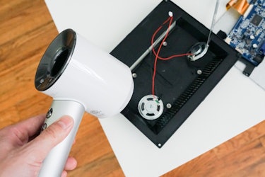 Use a blow dryer to loosen the glue and separate the speakers.