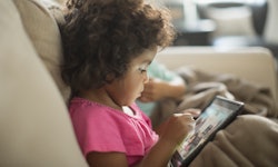 toddler on kindle tablet playing games