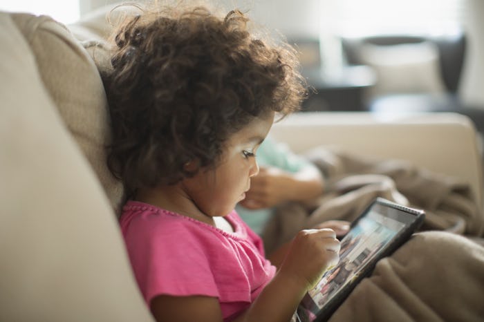 toddler on kindle tablet playing games