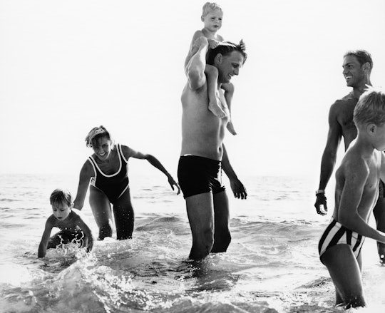 A family play in the surf in black and white photo from Getty Life collection