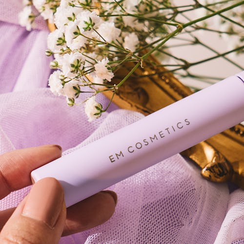 EM Cosmetics' Pick Me Up Mascara in tube, held by hand.