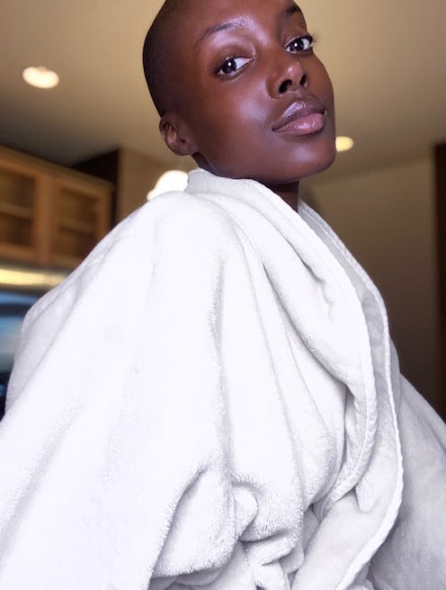 Madisin Rian posing in her living room while wearing a bathrobe