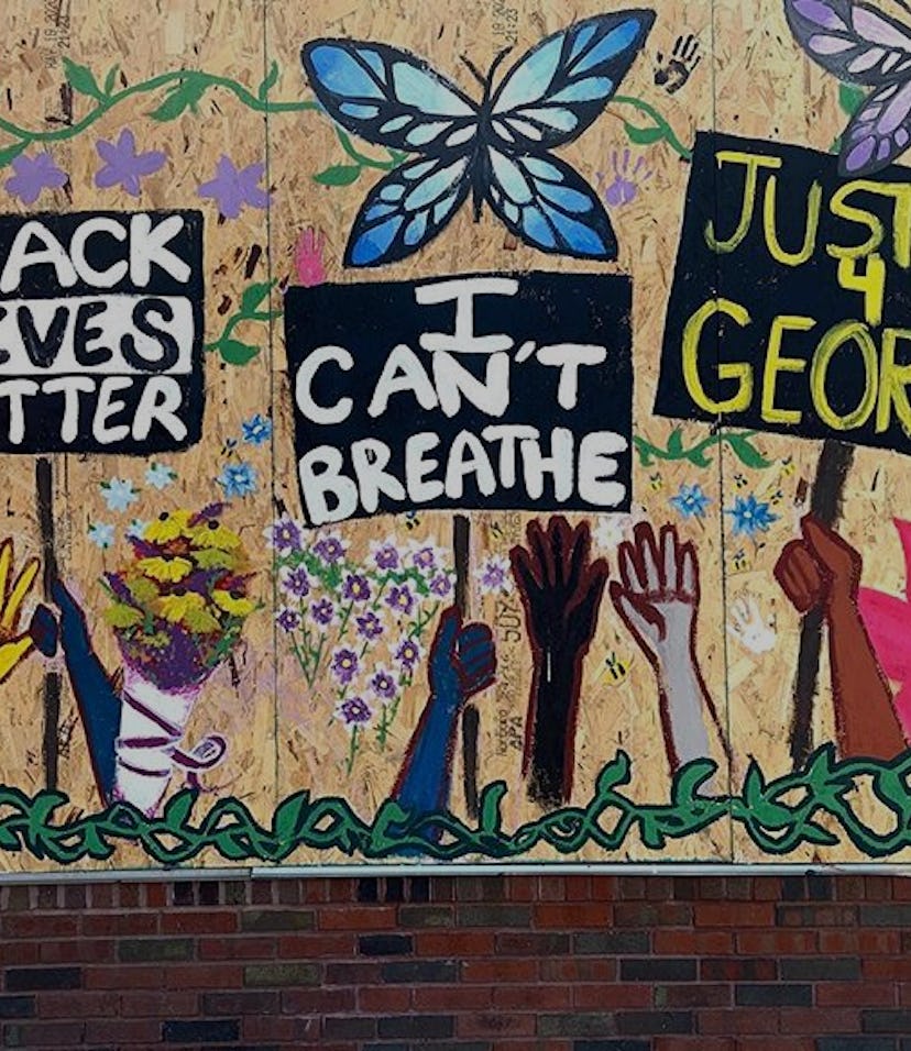 Mural of hands holding BLM protest signs